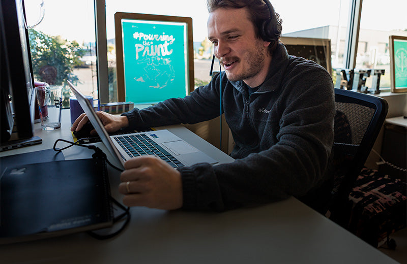 A man offering tech support on the phone in an office