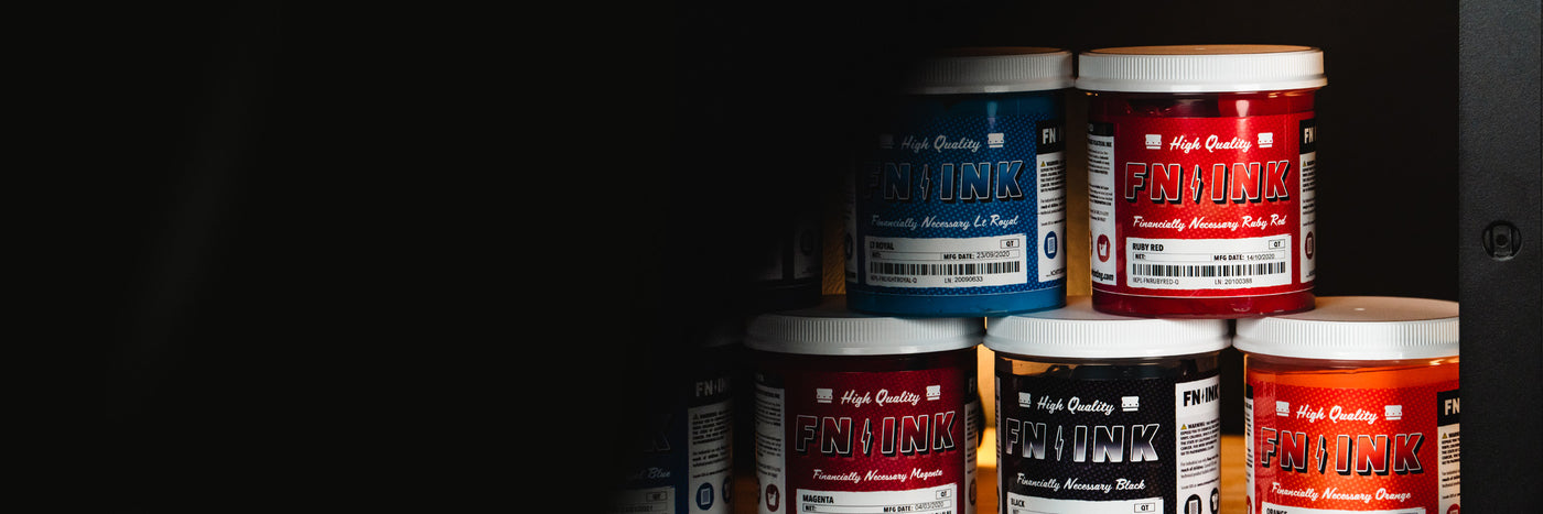 Stacked containers of FN-INK plastisol ink in assorted colors—blue, red, magenta, black, and orange—arranged in a neat pyramid against a dark background.